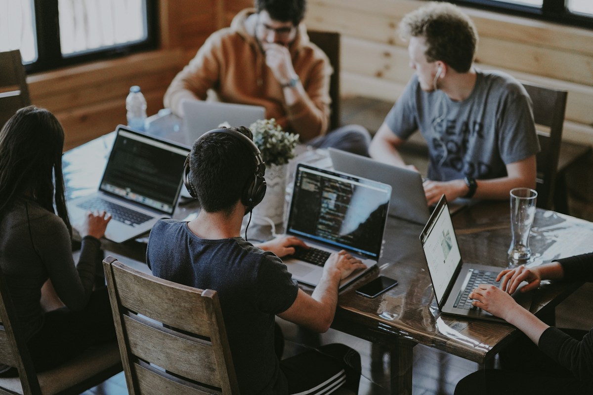 Creative team collaborating around a table to connect brand strategy with people